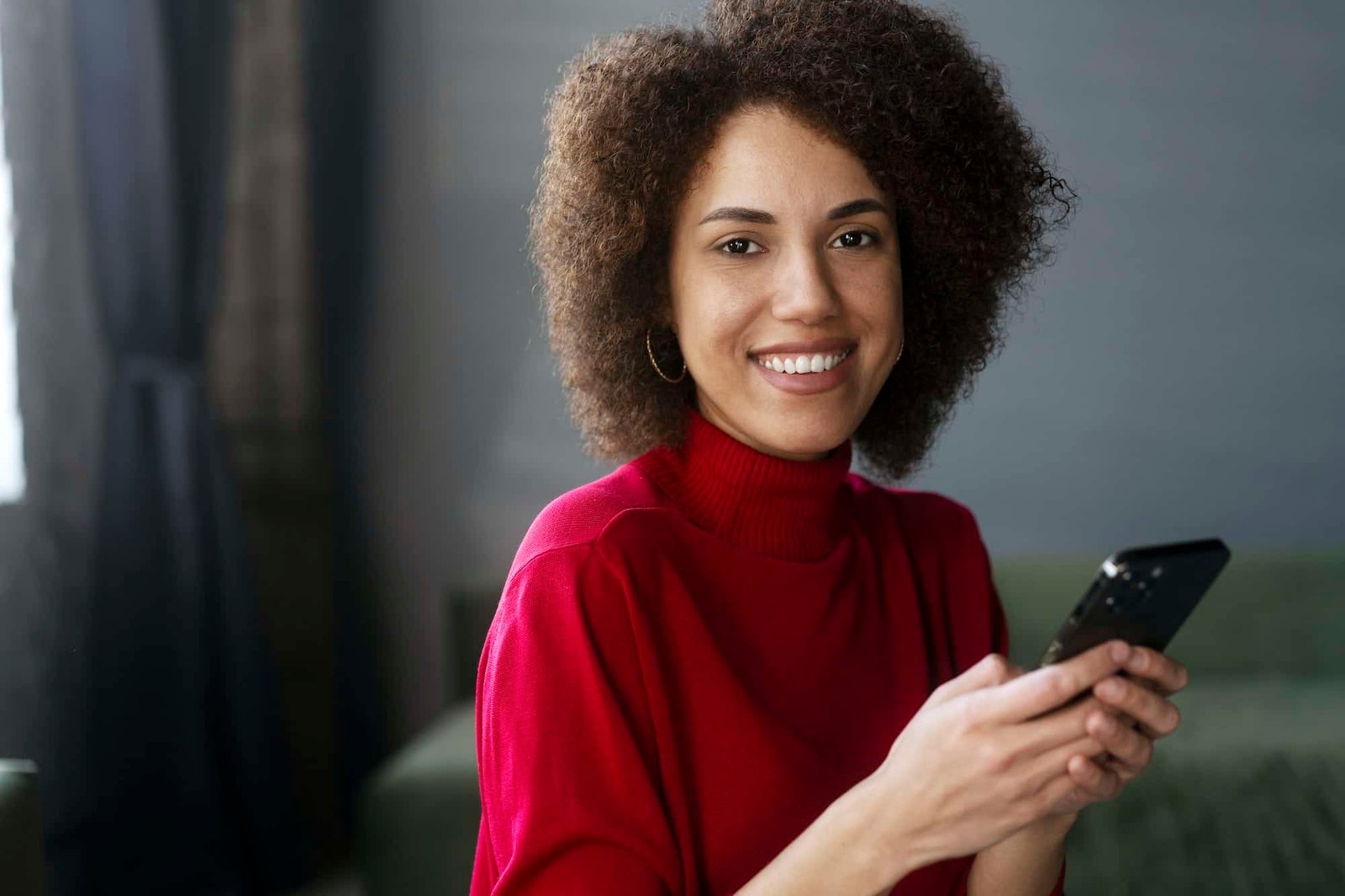 african american woman in red casual attire using mobile phone working online text messaging 1